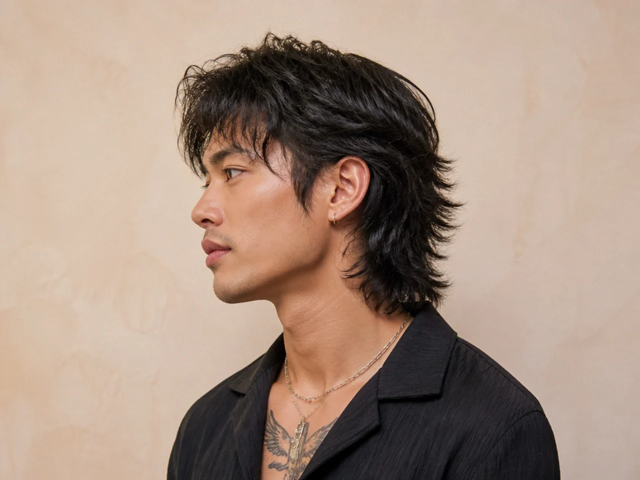 Thai fashion mullet on a young Thai man showing a colored highlight through the fringe and a layered shag back with wave