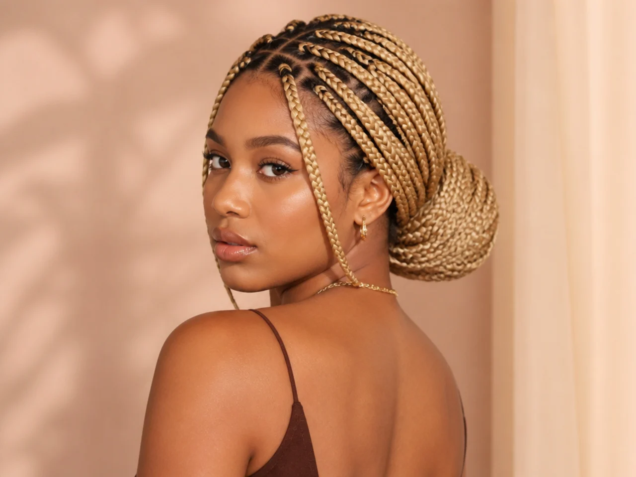 Blonde braids coiled into a low bun