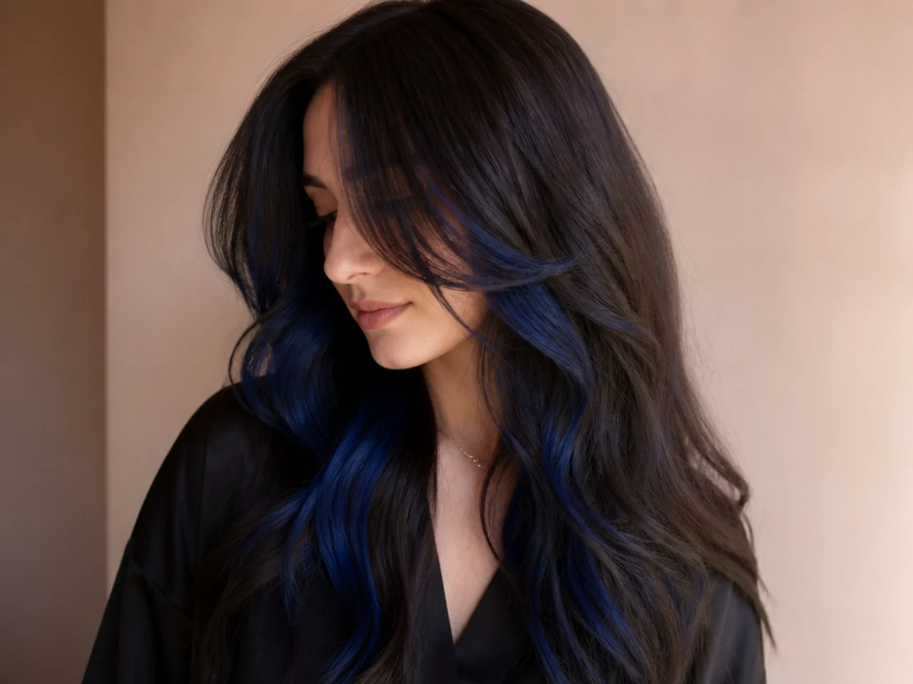 A midnight blue peekaboo panel blending with dark brown hair