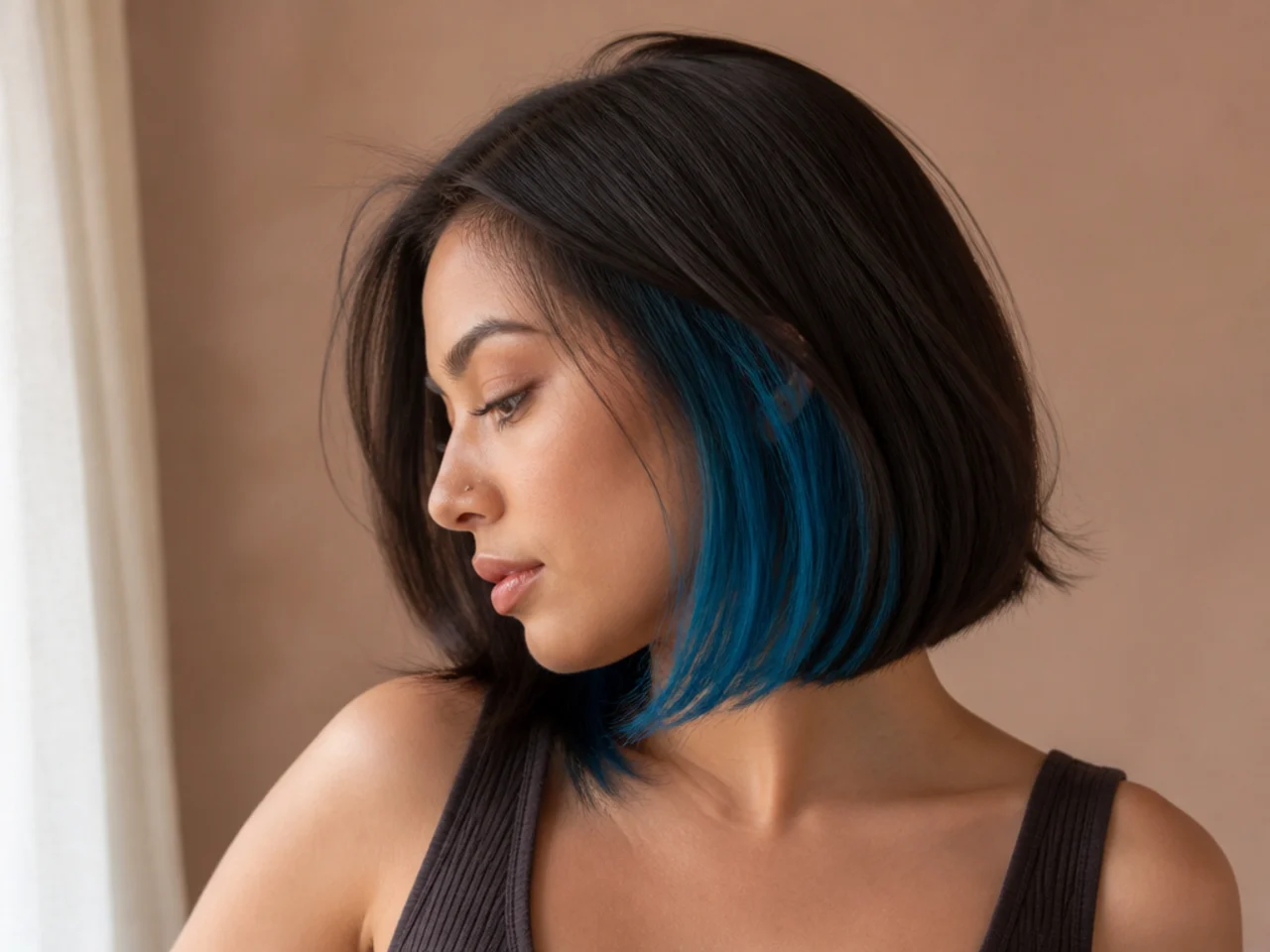 A blue peekaboo panel under a dark brunette bob