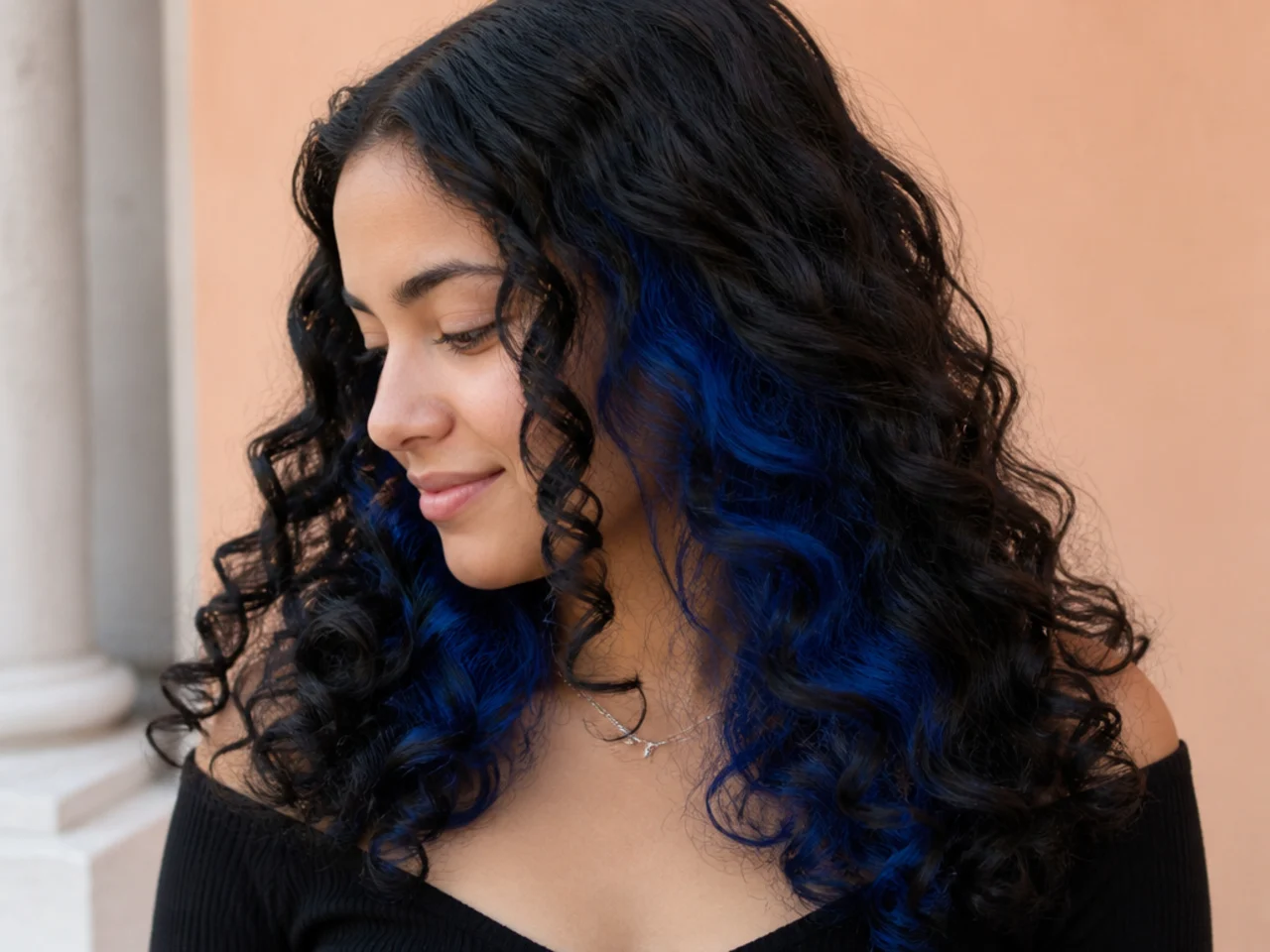 A blue peekaboo panel showing through dark curls
