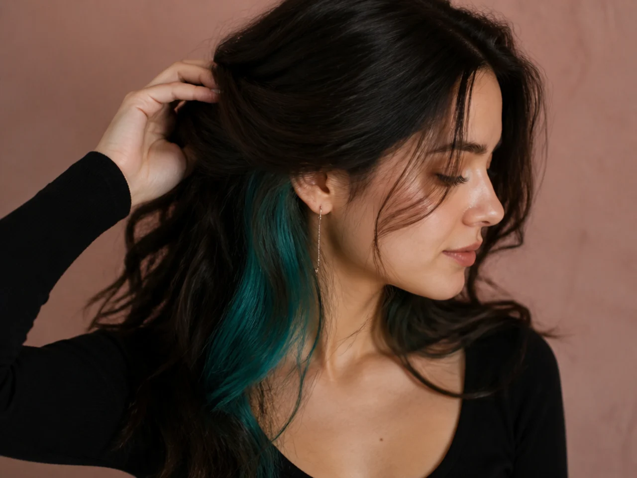 A teal peekaboo panel under dark brunette hair