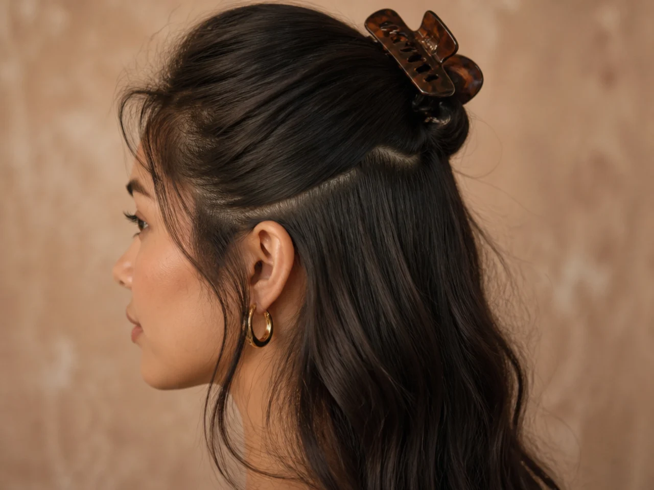 Top section of hair clipped flat against the crown leaving the under layer loose