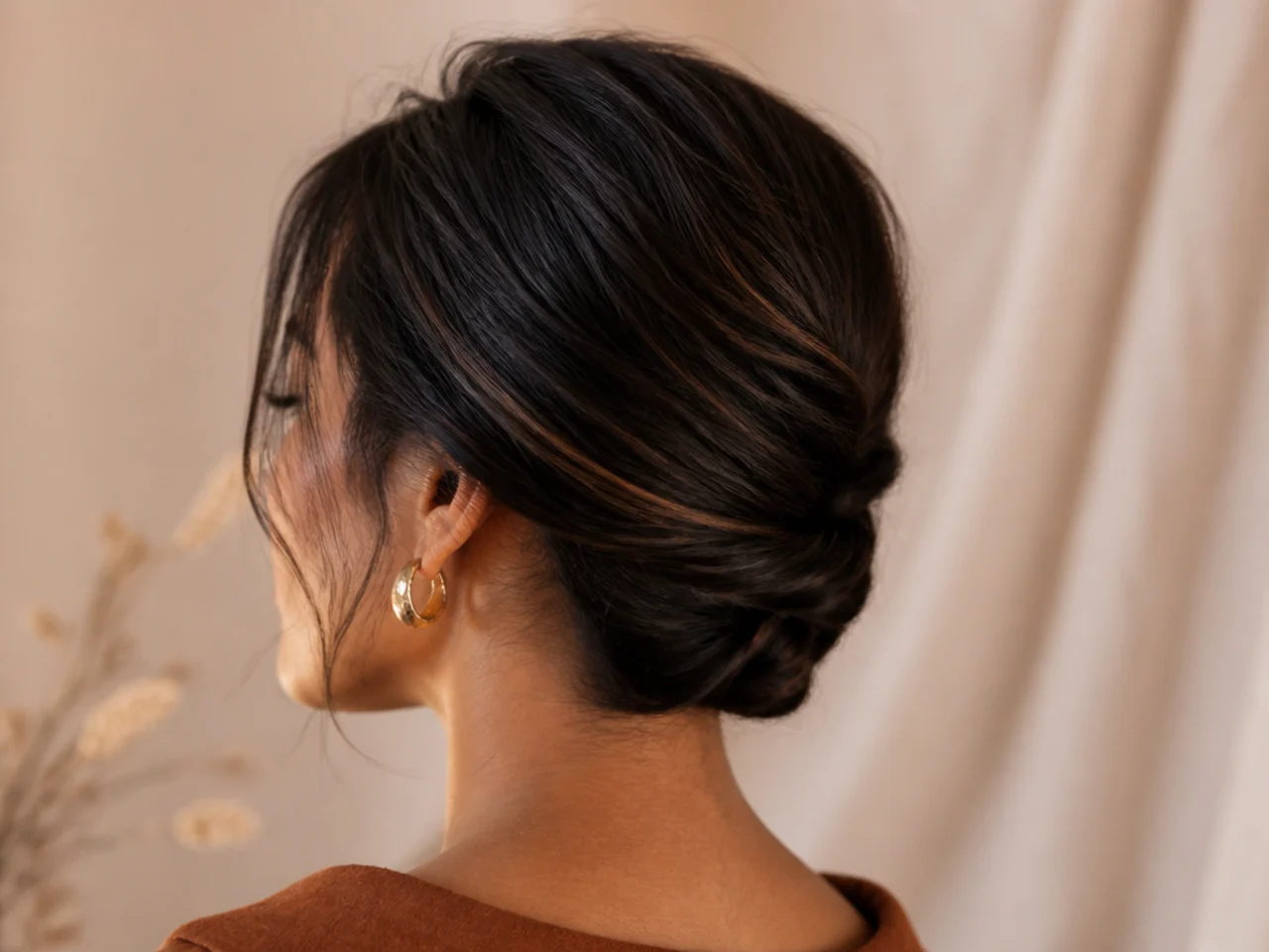 The lower lengths twisted and pinned flat against the neck out of the way