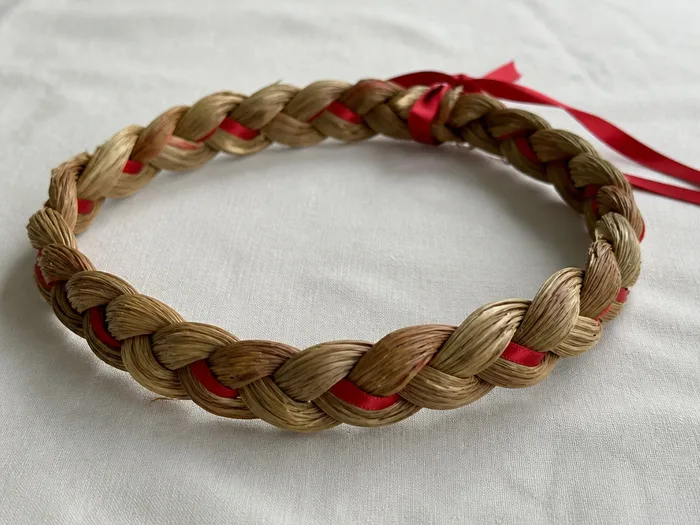 Braided crown Christmas hairstyle with red ribbon woven through