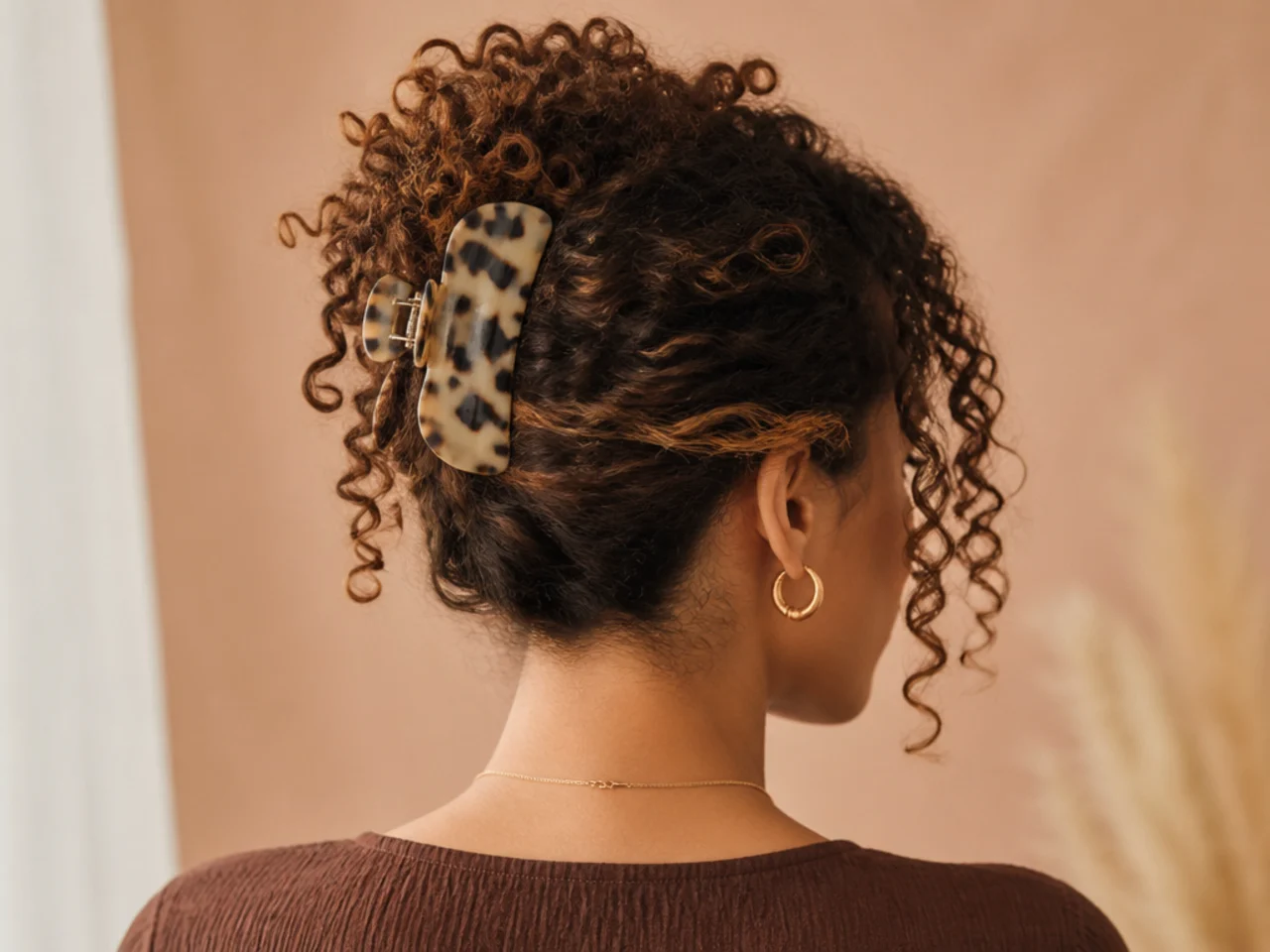 A coily updo held with a wide claw clip