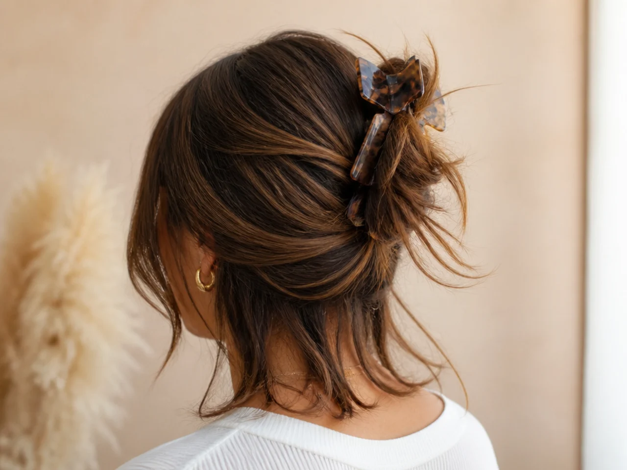 A clip working loose from a layered shoulder-length cut