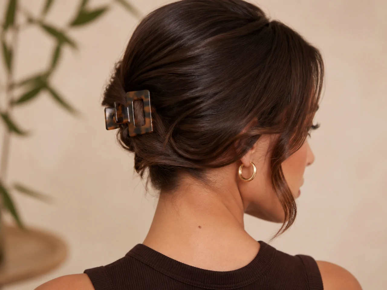 A deep side part held with a small clip