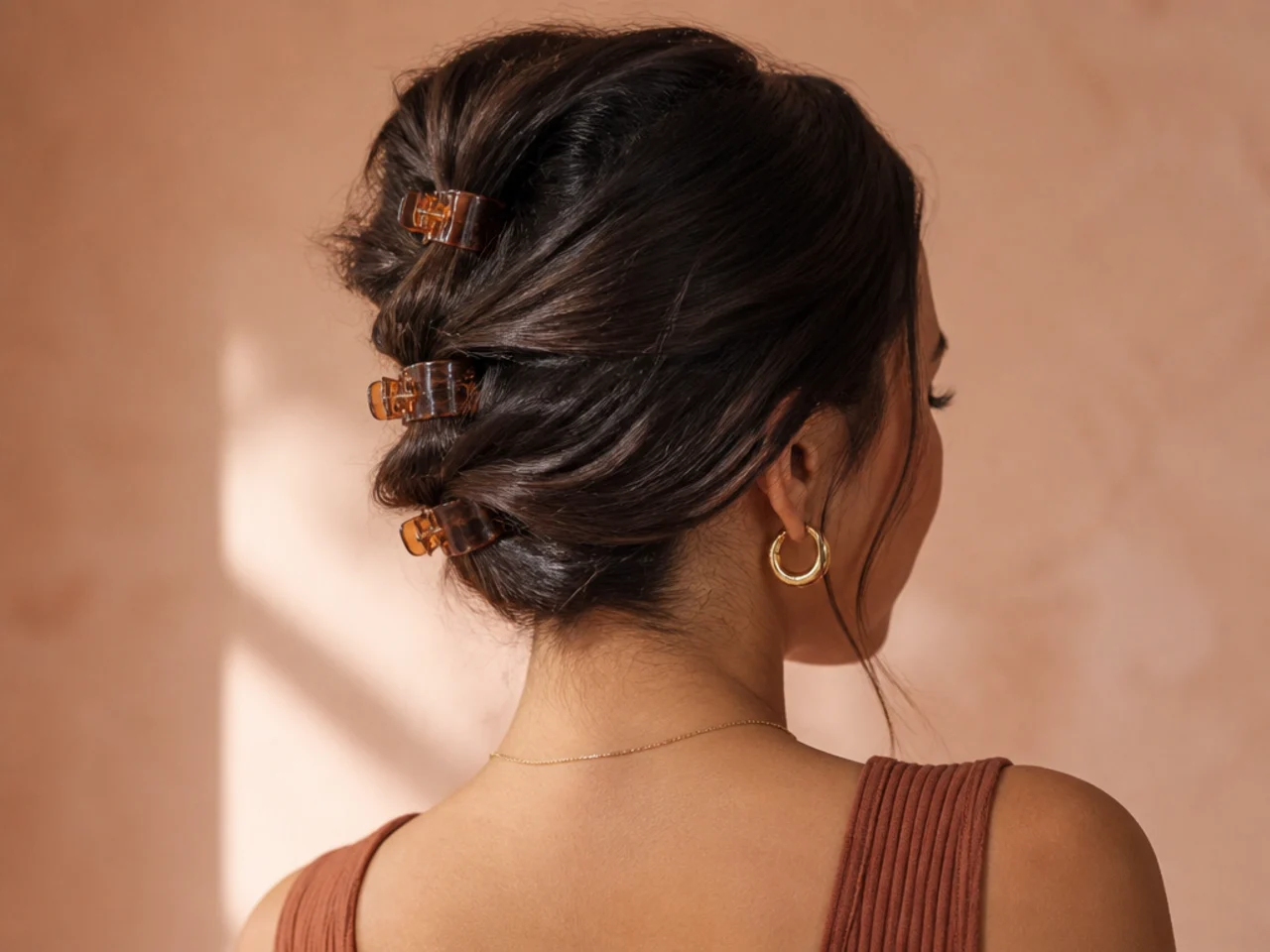 Several small claw clips spaced down the length of the hair