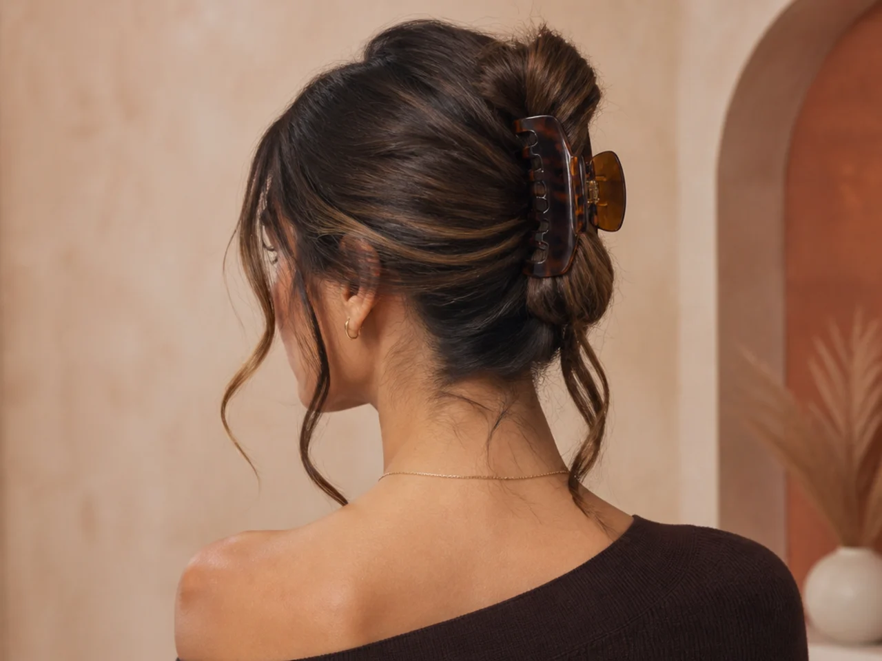 Claw clip updo with tendrils released at the temples