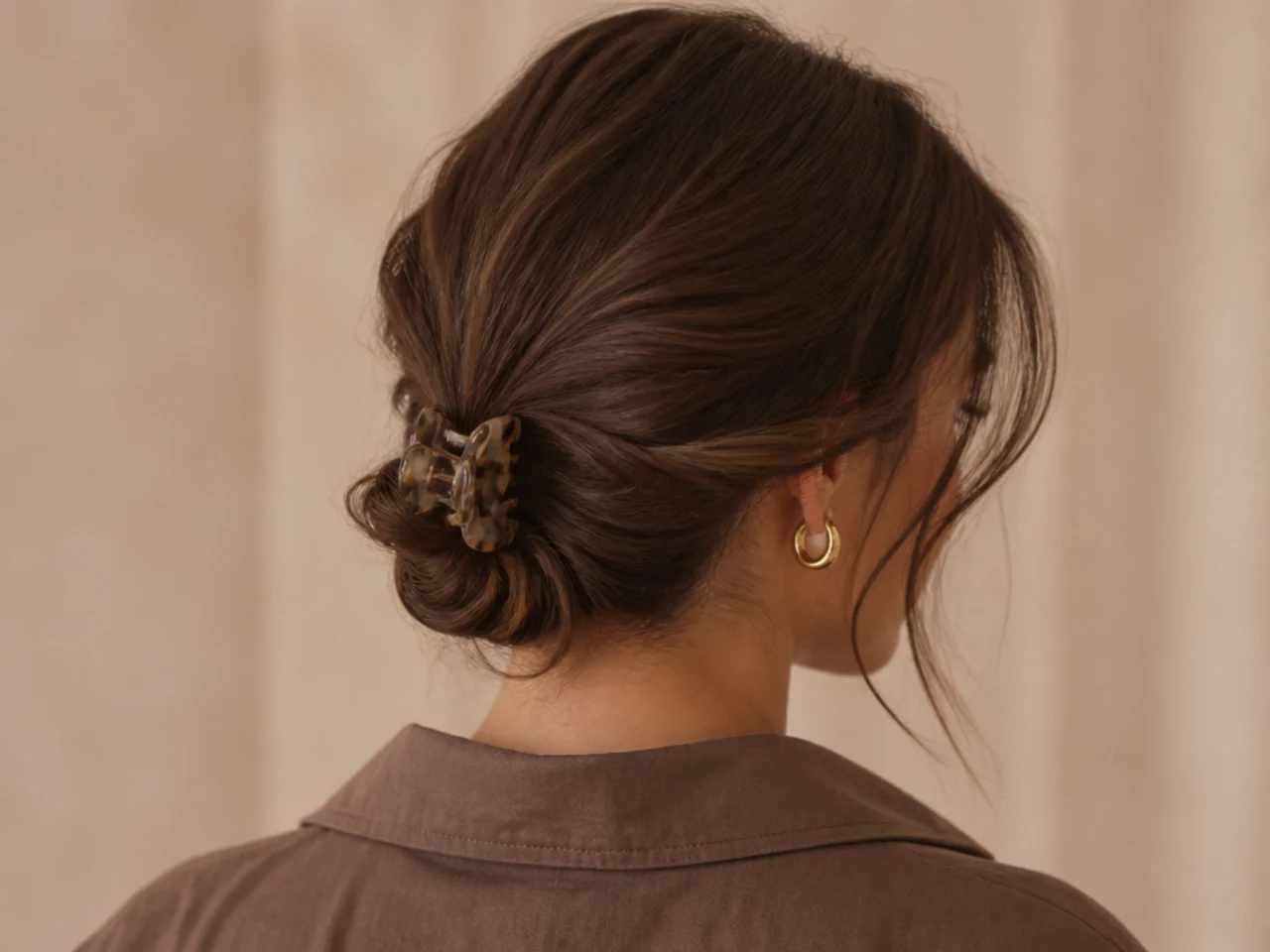Low chignon secured with a claw clip at the nape