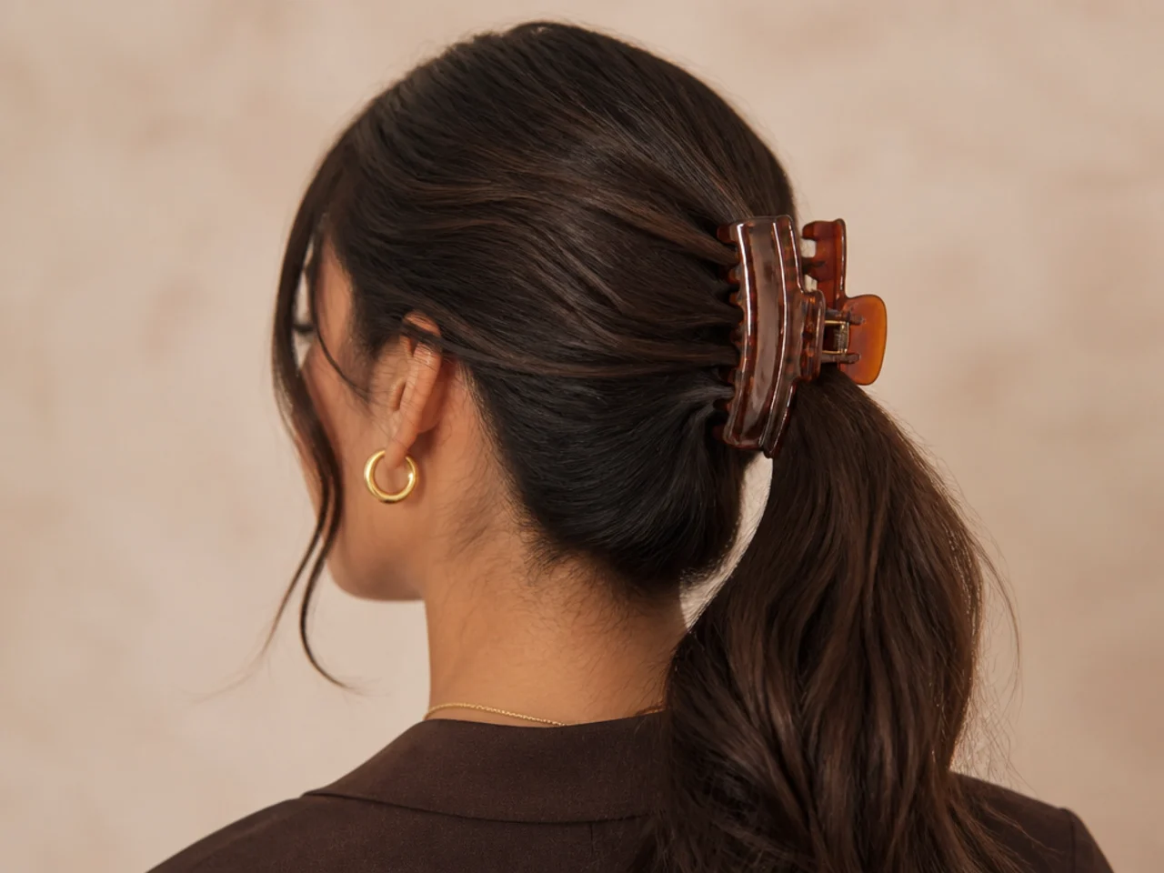 A claw clip fastened over a secured ponytail