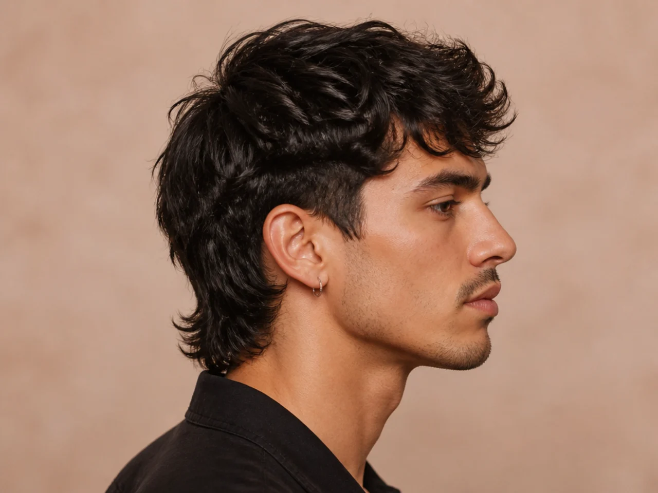 Reverse comma mullet with heavier front weight, a bold defined curl, and a subtle short mullet at the nape