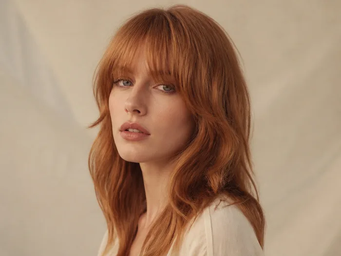 Cowboy copper hair with face-framing curtain bangs