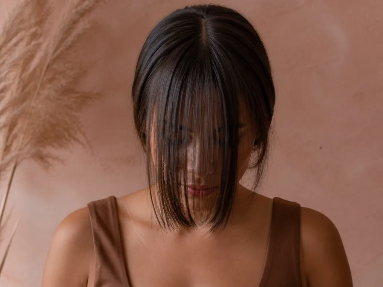 A fringe section combed flat forward over the face