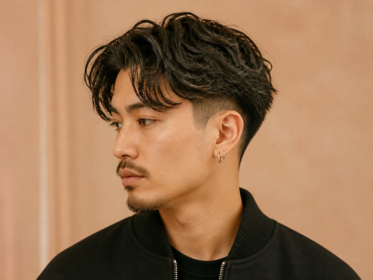 Burst fade curtain haircut with a semicircle fade radiating behind the ear and a four-inch curtain top