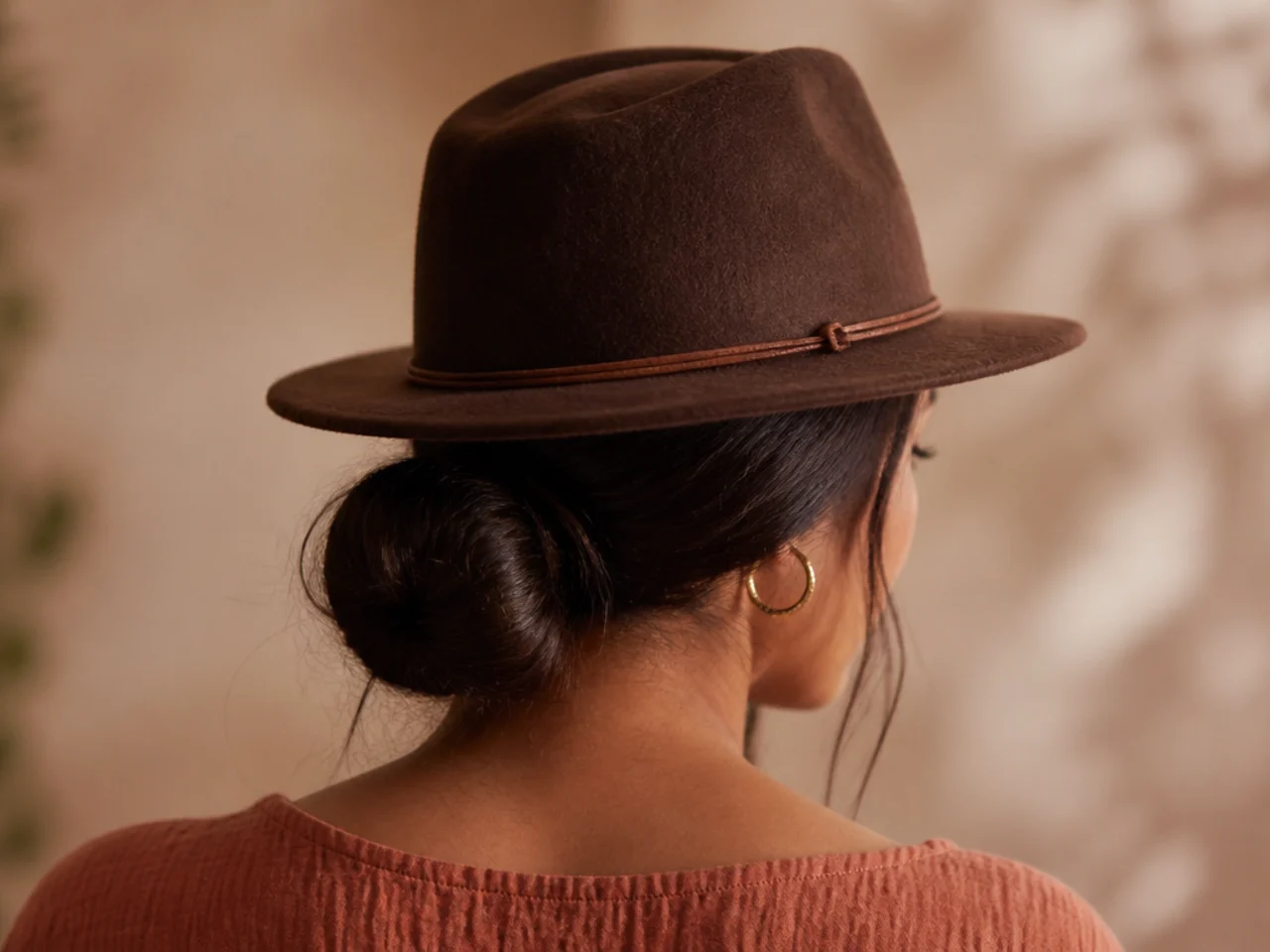 A low bun worn under a hat