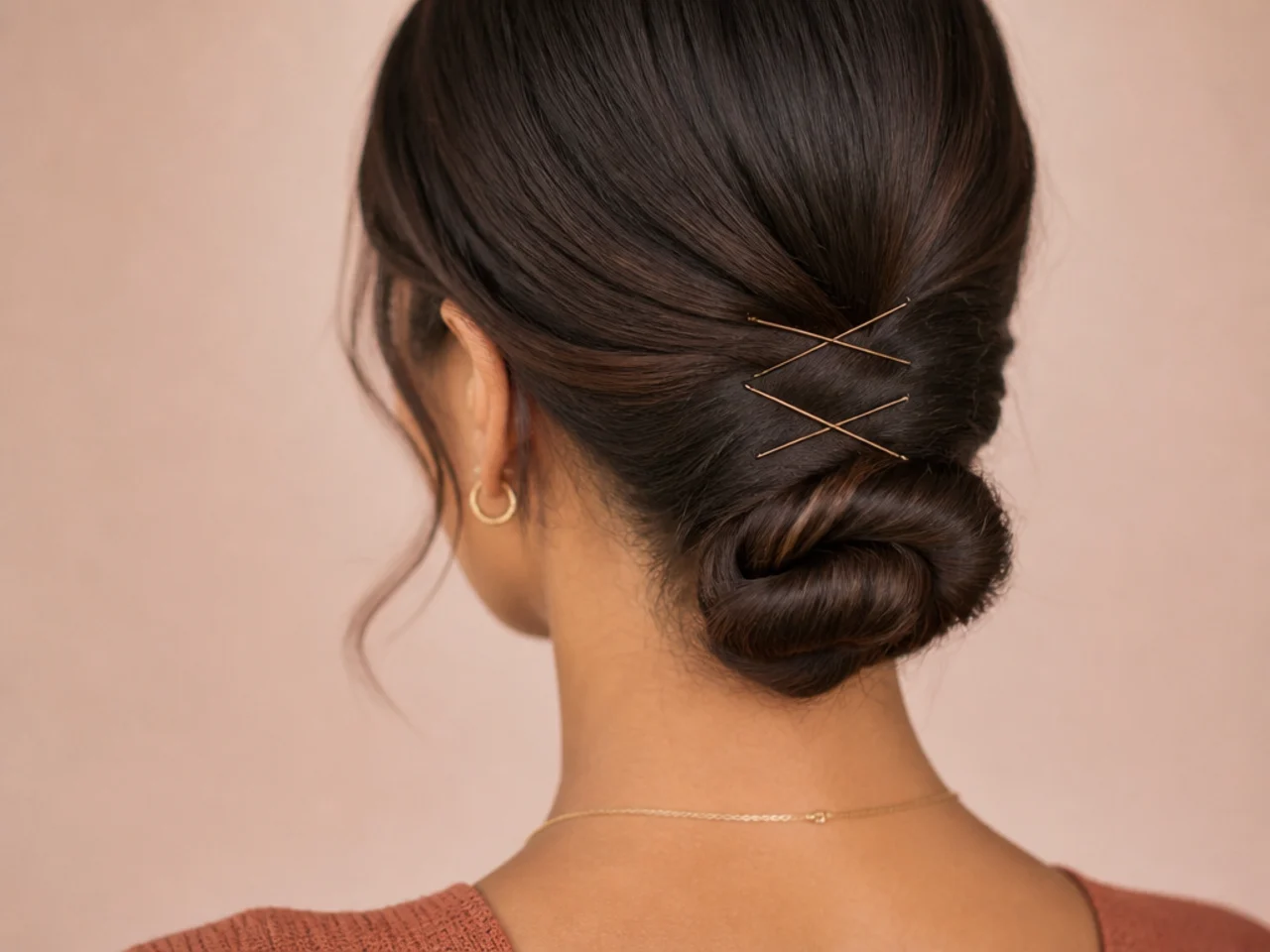 A bun anchored with two pairs of crossed pins