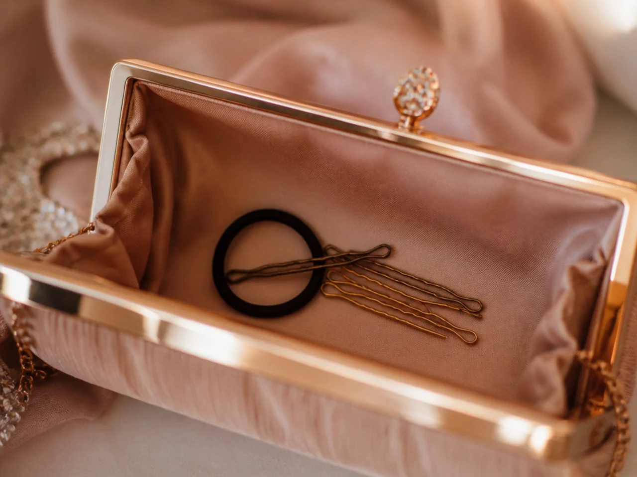 A small kit of pins and an elastic tucked into an evening bag