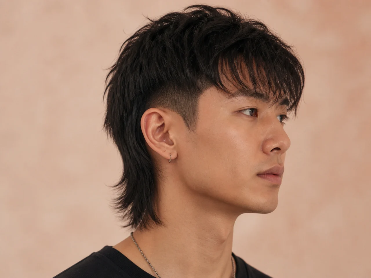 Two-block fringe mullet with an undercut side and a heavy blunt fringe falling over the brow