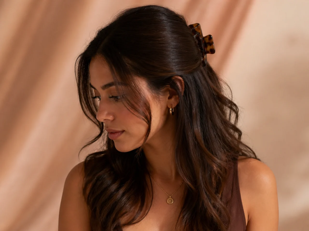 Half-up hair held with a claw clip