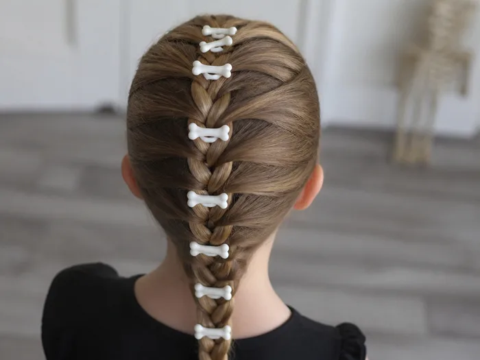 Skeleton bone braid Halloween hairstyle for kids with plastic bones