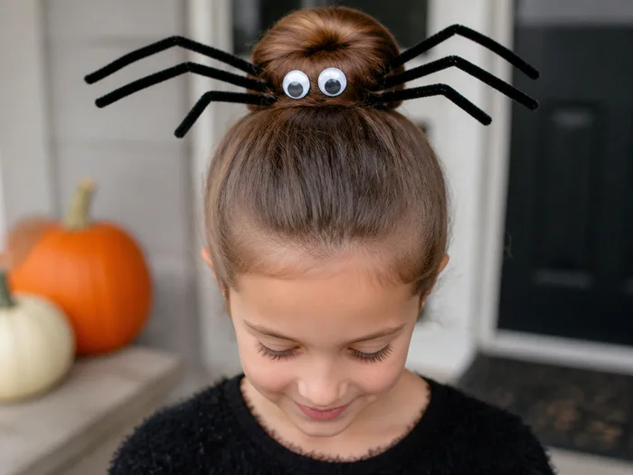 Spider bun Halloween hairstyle for kids with pipe cleaner legs