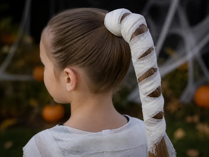 Mummy wrap ponytail Halloween hairstyle for kids with white strips