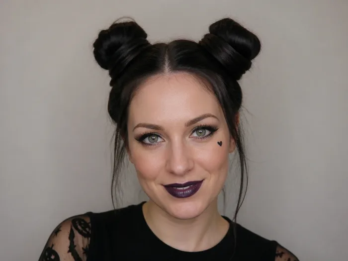 Long hair in double space buns with the lengths wrapped around the bases, playful Halloween style