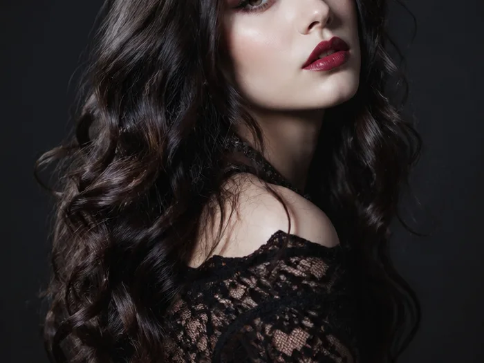Gothic loose curls with dark roots and glossy lengths, romantic vampire Halloween hair