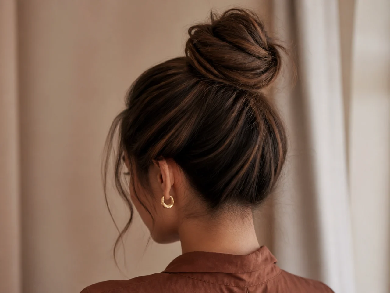 A high bun sitting on the crown and slipping