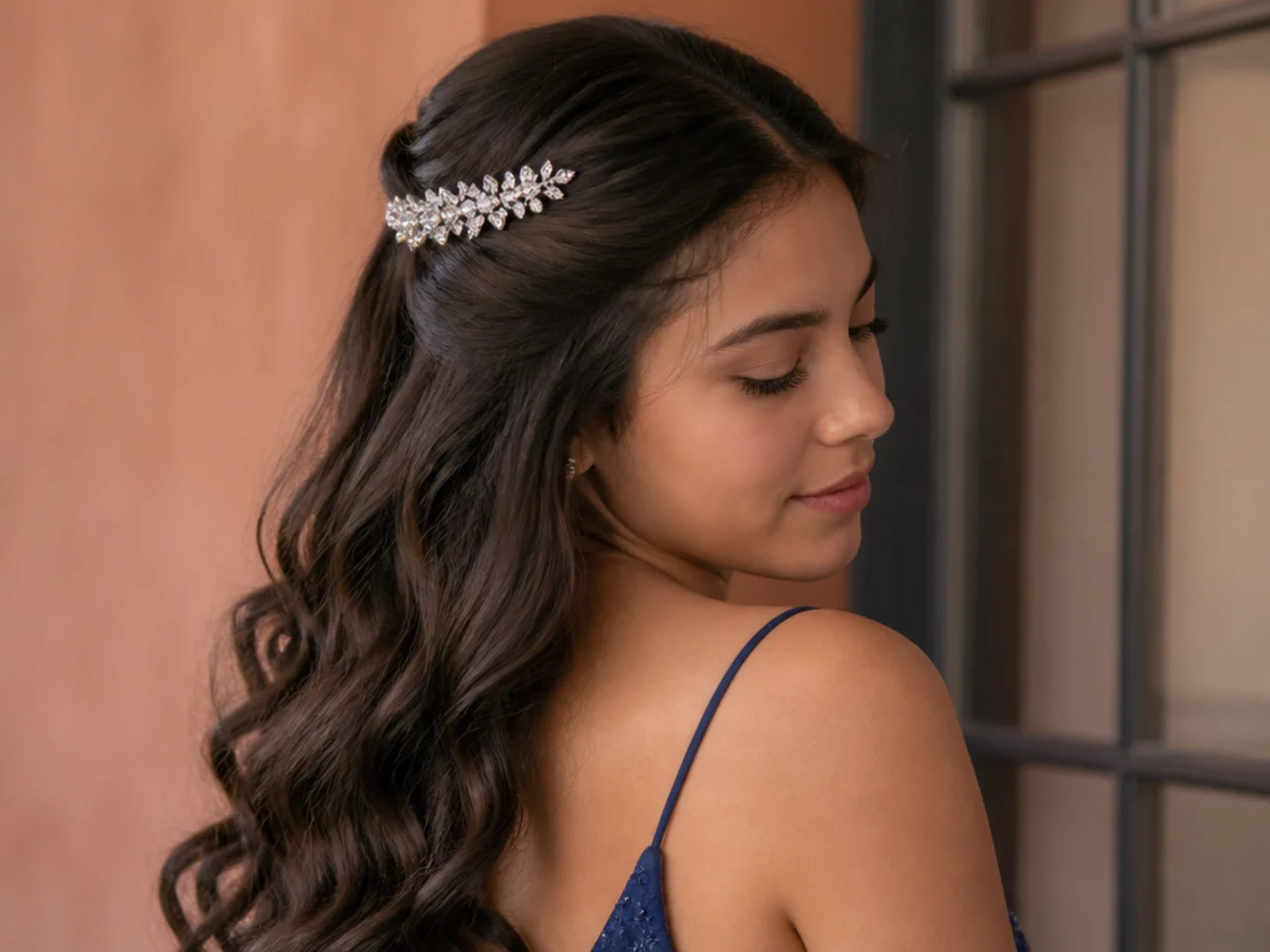 A sparkling crystal barrette fastened over the top section of long hair