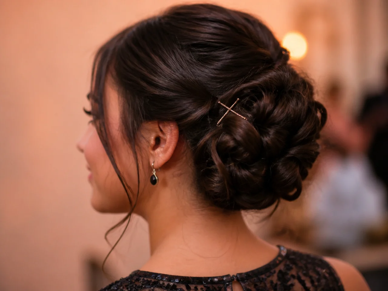 Two bobby pins crossed against each other inside a medium length updo