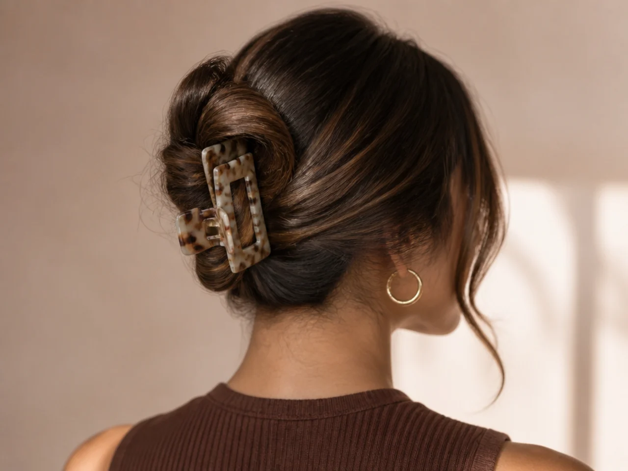 Hair gathered loosely at the nape