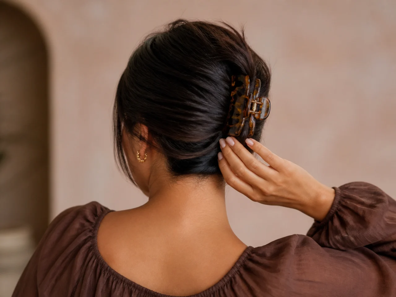 Hair held at the occipital bone at the back of the head
