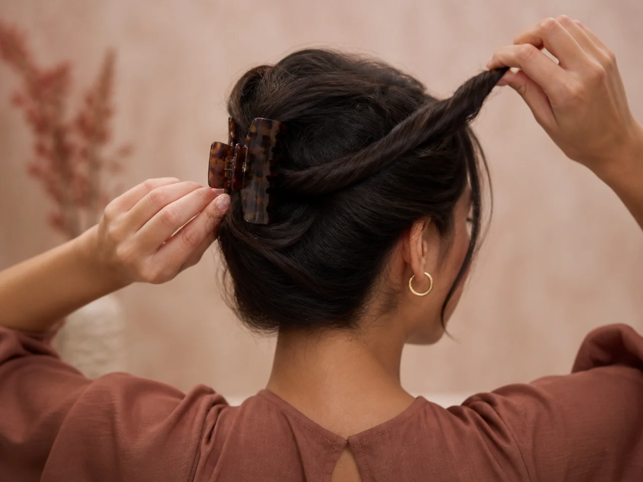 Gathered hair being twisted away from the face