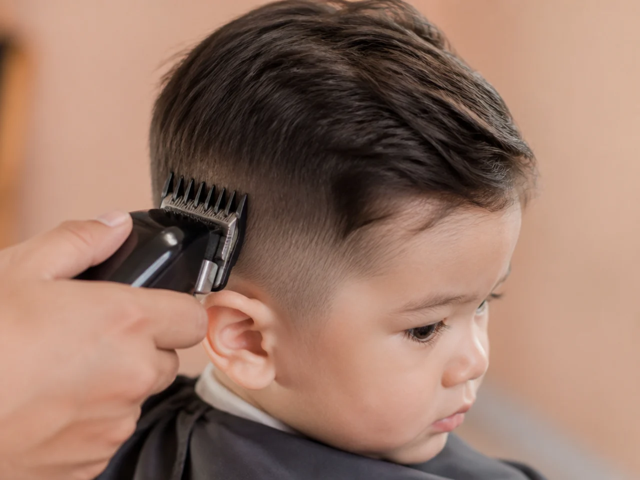 A number four guard being run up the side of a toddler's head