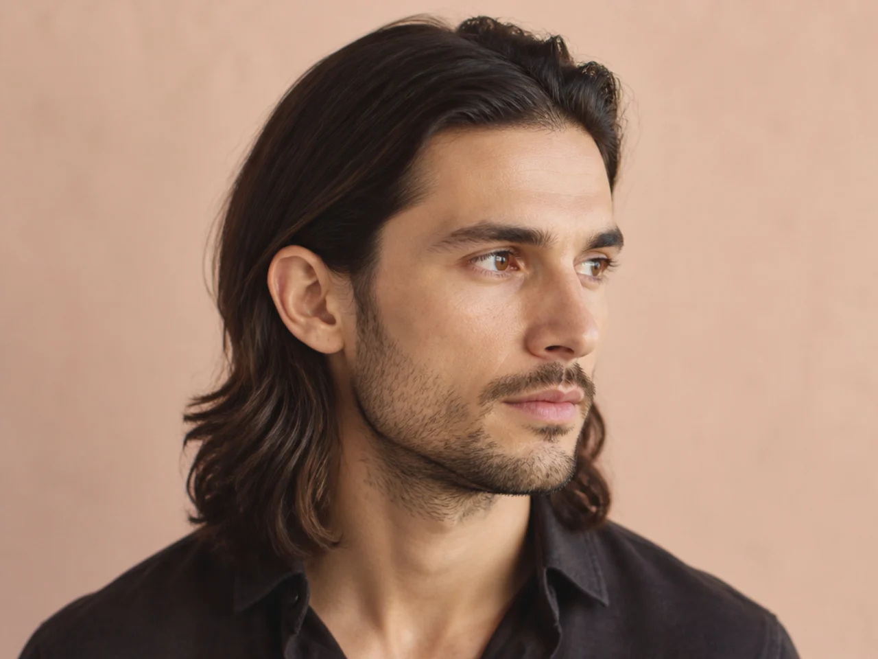 Man with long hair tucked cleanly behind both ears, side profile showing clean line