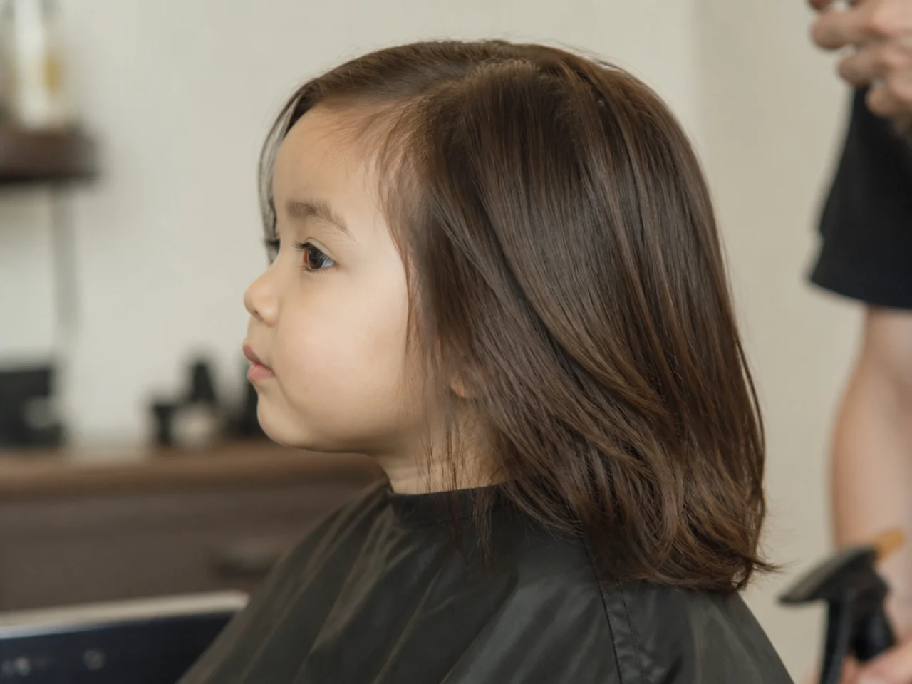 A toddler boy with collarbone-length hair and blunt ends
