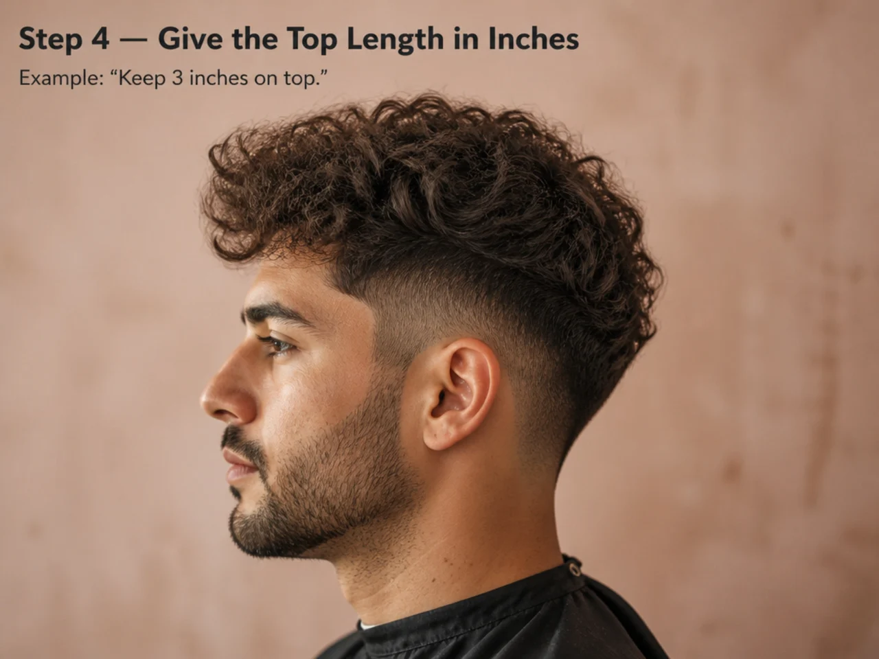 Barber holding two fingers up next to a client's crown to measure roughly two inches of top length