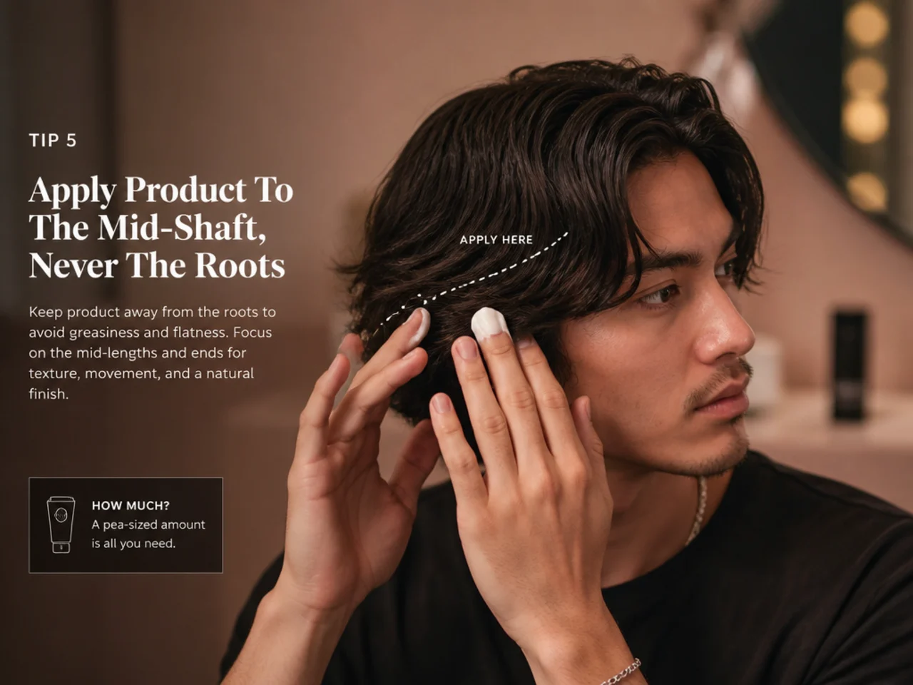 Man working matte clay through the mid-lengths of medium length hair with fingertips, palms held away from the scalp
