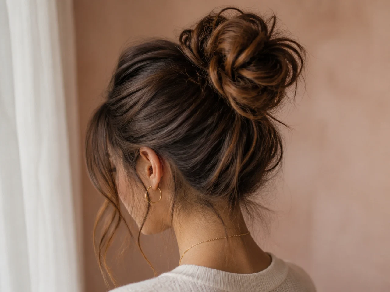 A messy bun with a backcombed base