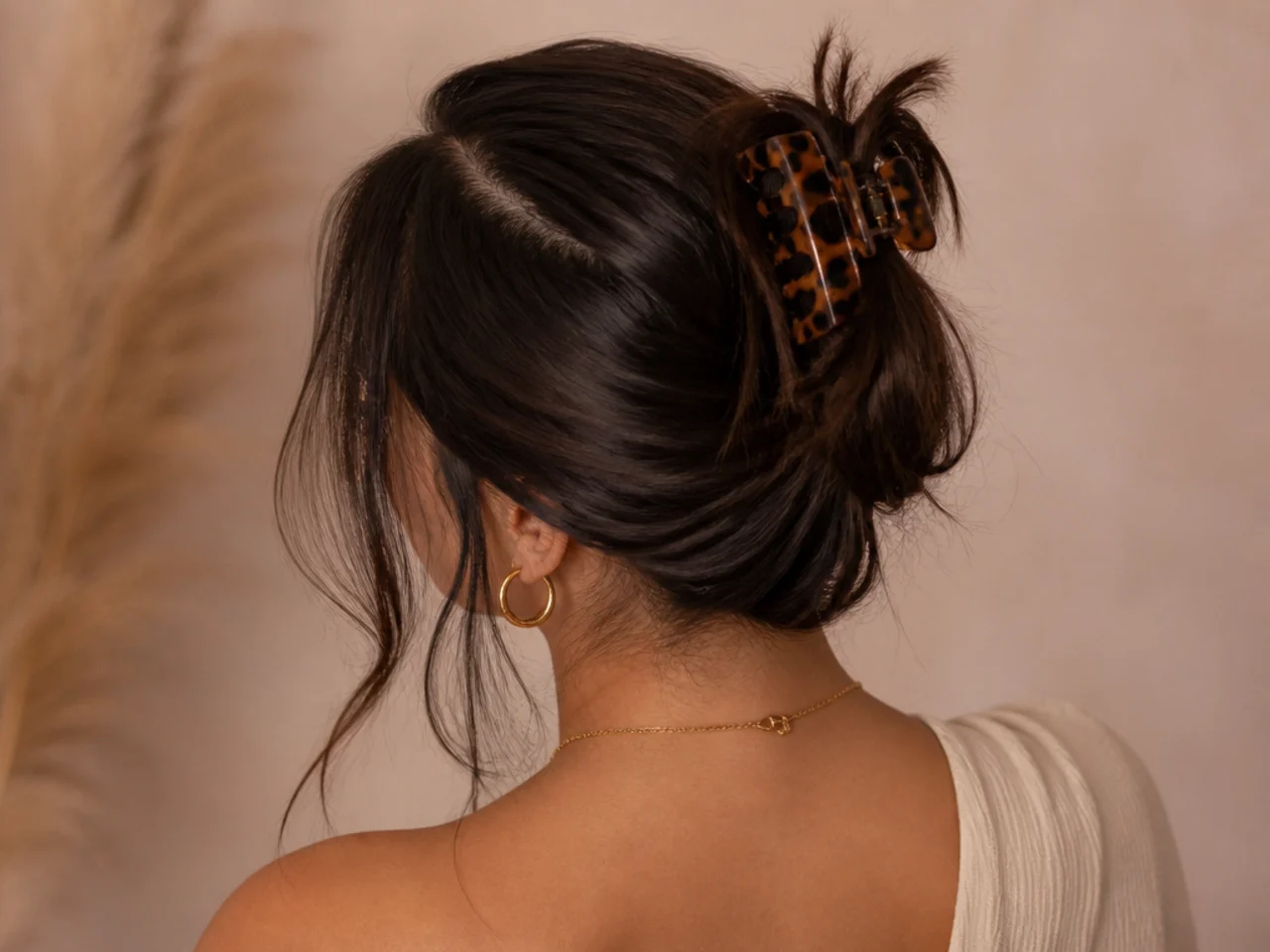 A messy bun with a sharp deep parting