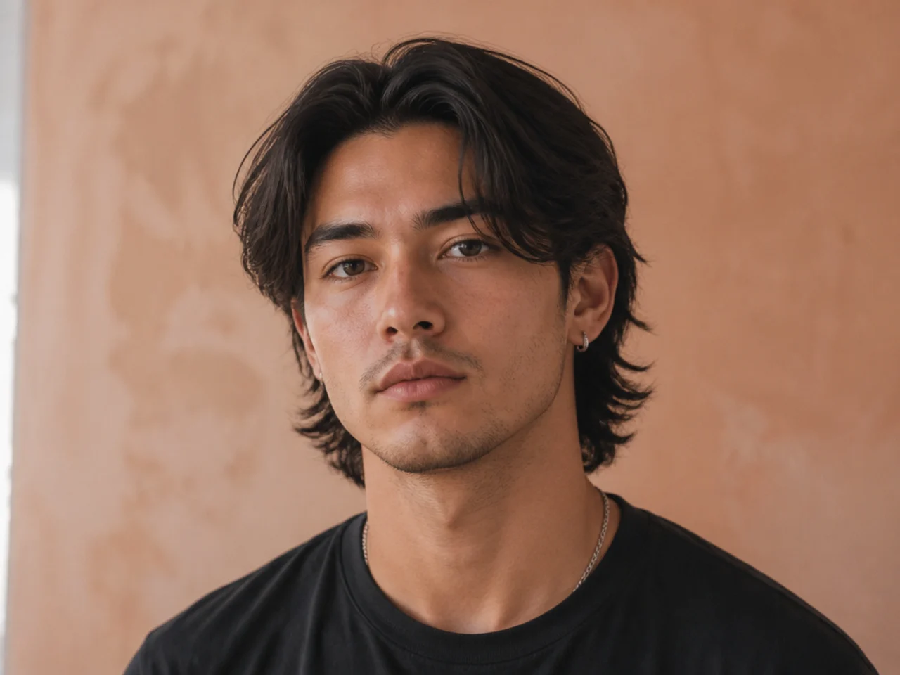Middle part mens haircut with modern mullet extending down the nape