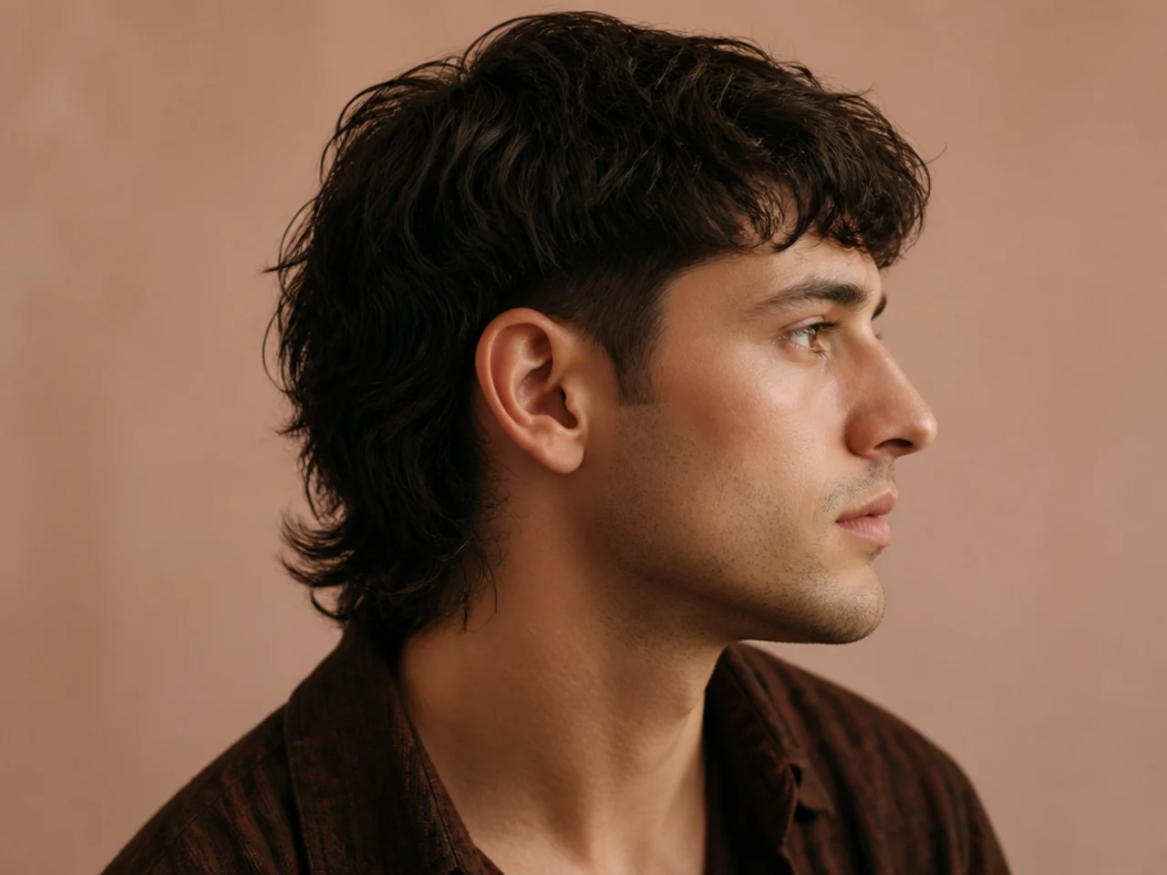 A mullet with softly tapered sides finishing short but not bare