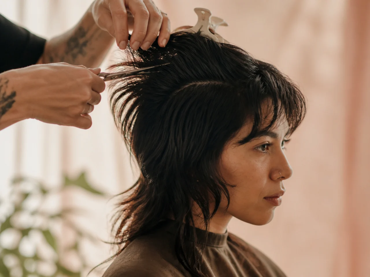 Scissors removing interior weight at the crown of a growing mullet