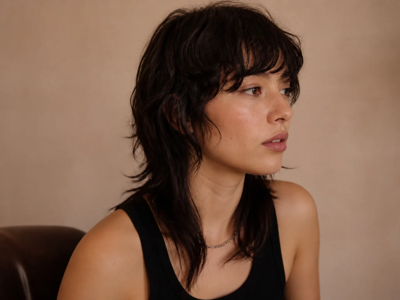 A mullet cut with a blunt perimeter and layered interior