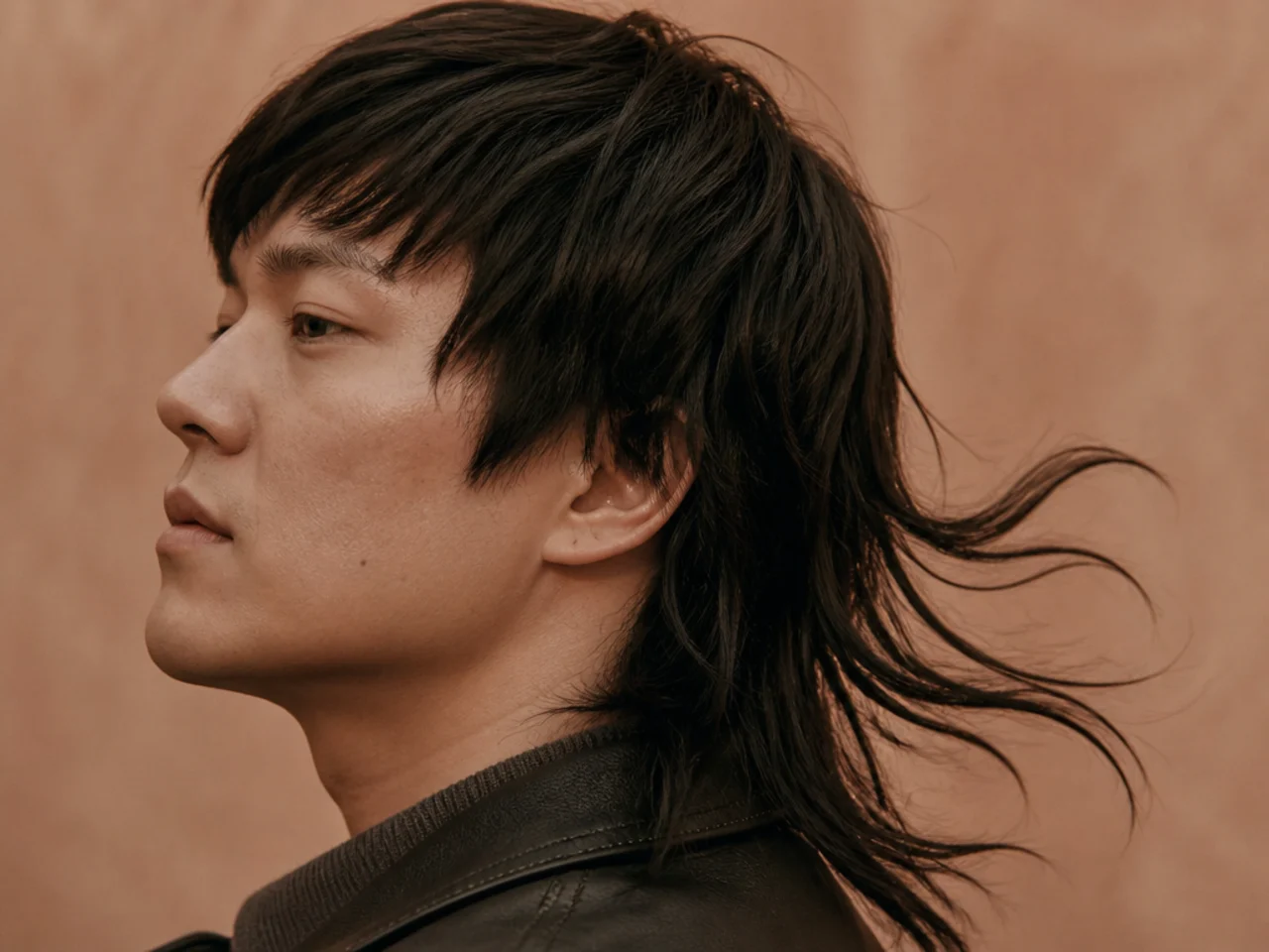 A drawn mullet with the tail lifting into separate clumps in wind