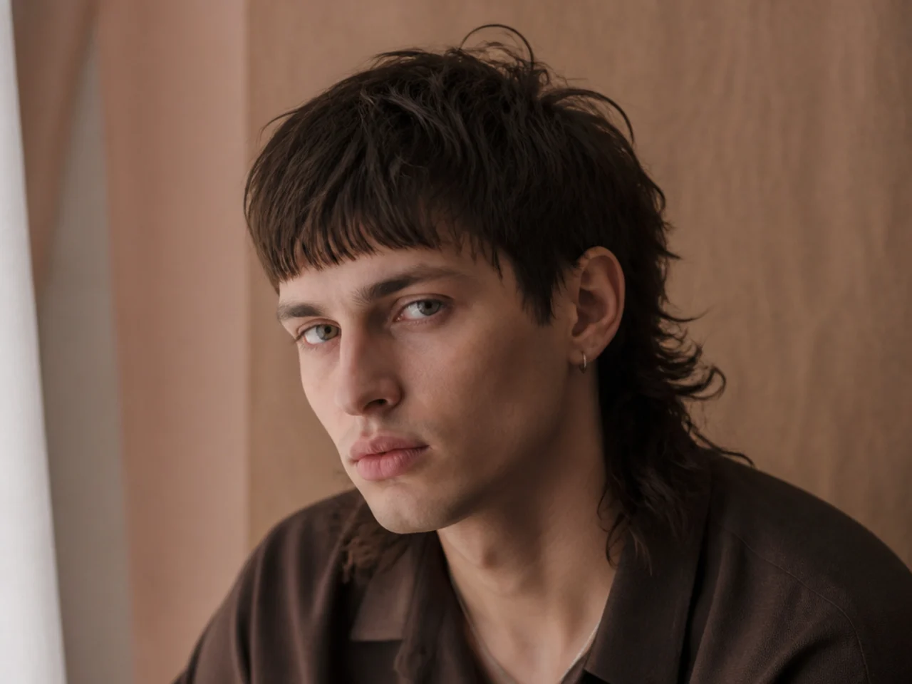 A mullet with a blunt fringe across the brow