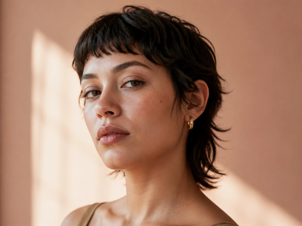 A scissor cut short mullet keeping natural texture at the sides